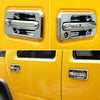 Close-up view of chrome trim door handles on a yellow Hummer H2 vehicle.