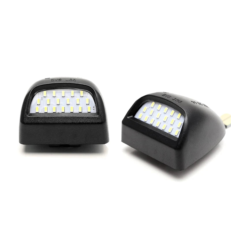 A pair of high-intensity LED license plate lights, black and silver, shown against a white background.