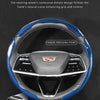A close-up view of a black steering wheel cover with blue and black carbon fiber accents, showing the contoured grip design.