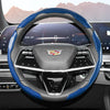 Close-up view of a black steering wheel with blue carbon fiber accents and an airbag cover.