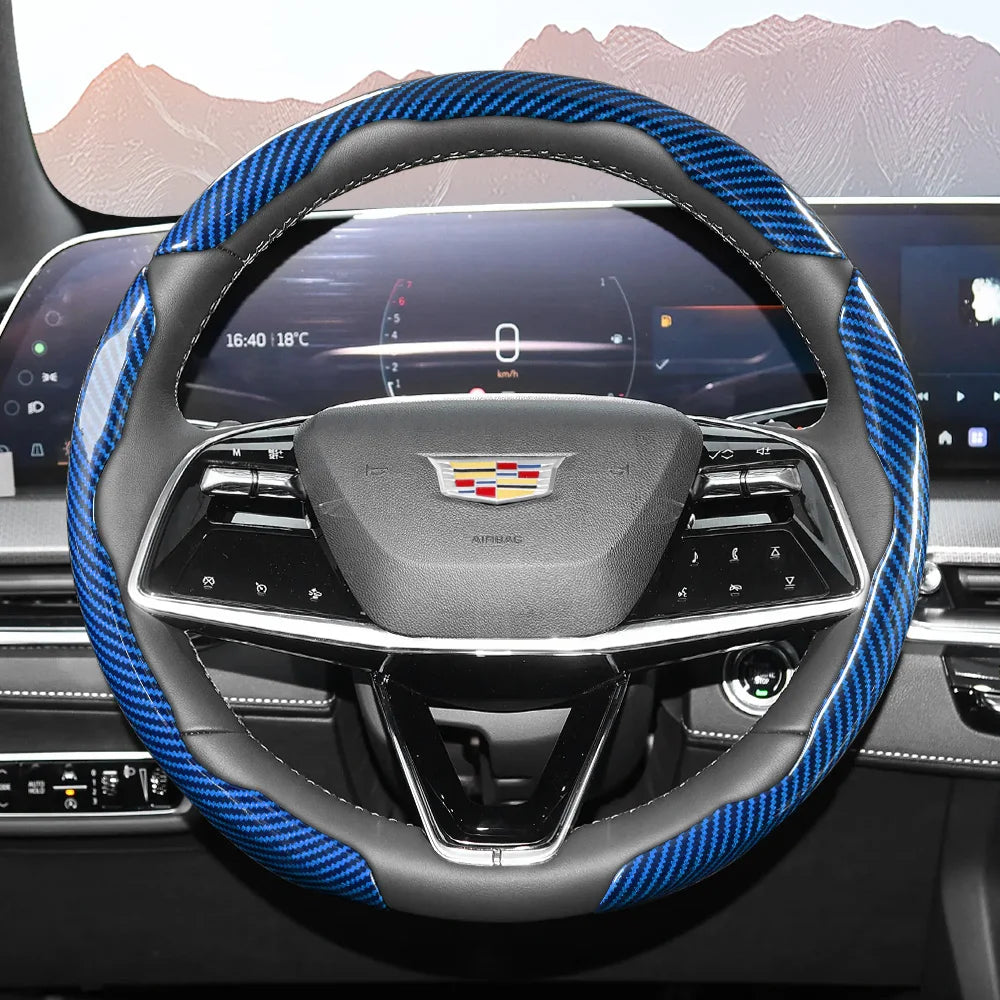 Close-up view of a black steering wheel with blue carbon fiber accents and an airbag cover.