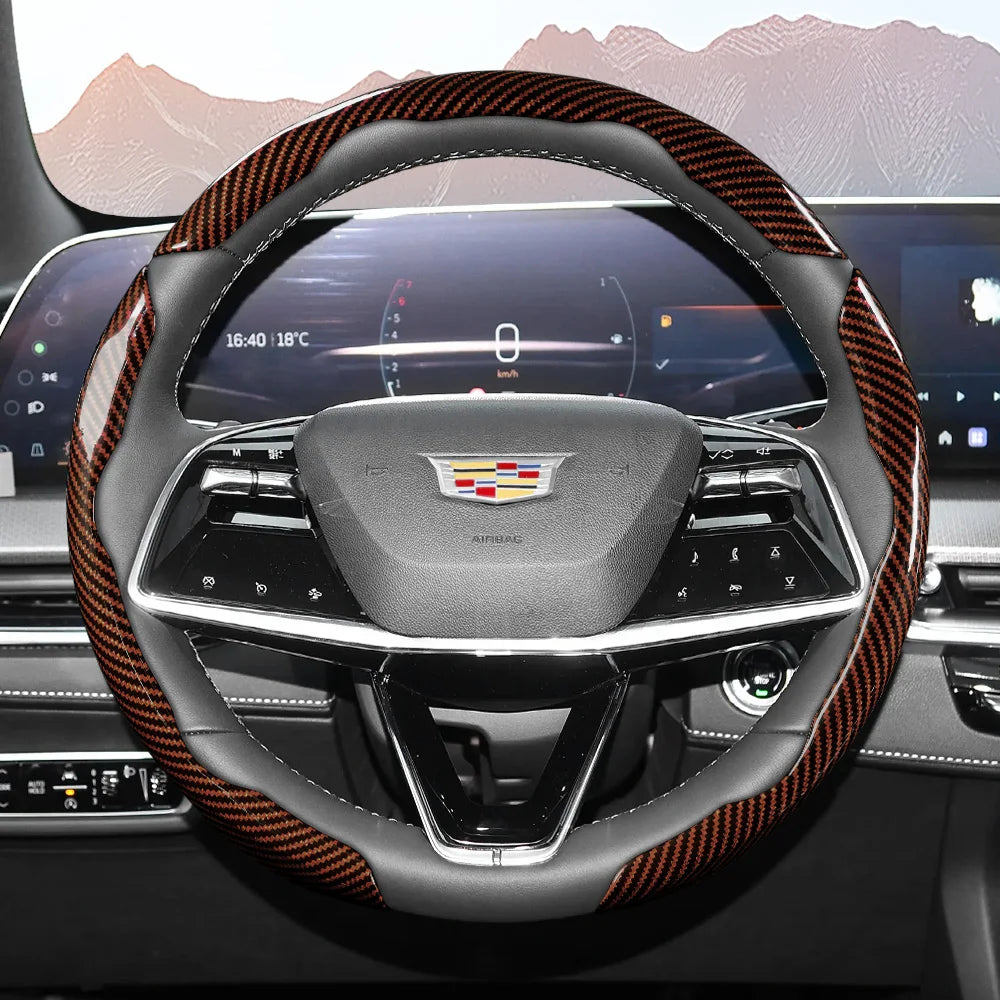 Close-up view of a sporty carbon fiber steering wheel cover inside a car cockpit.