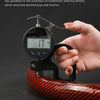 A hand holds a light and thin design steering wheel cover made of red carbon fiber material.