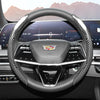 A close-up view of a sporty carbon fiber steering wheel cover inside a car cockpit.