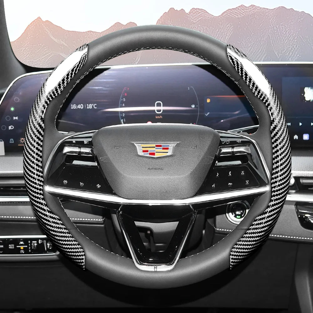 A close-up view of a sporty carbon fiber steering wheel cover inside a car cockpit.