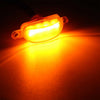 A bright yellow LED light kit mounted on a grille, illuminating the surrounding area.