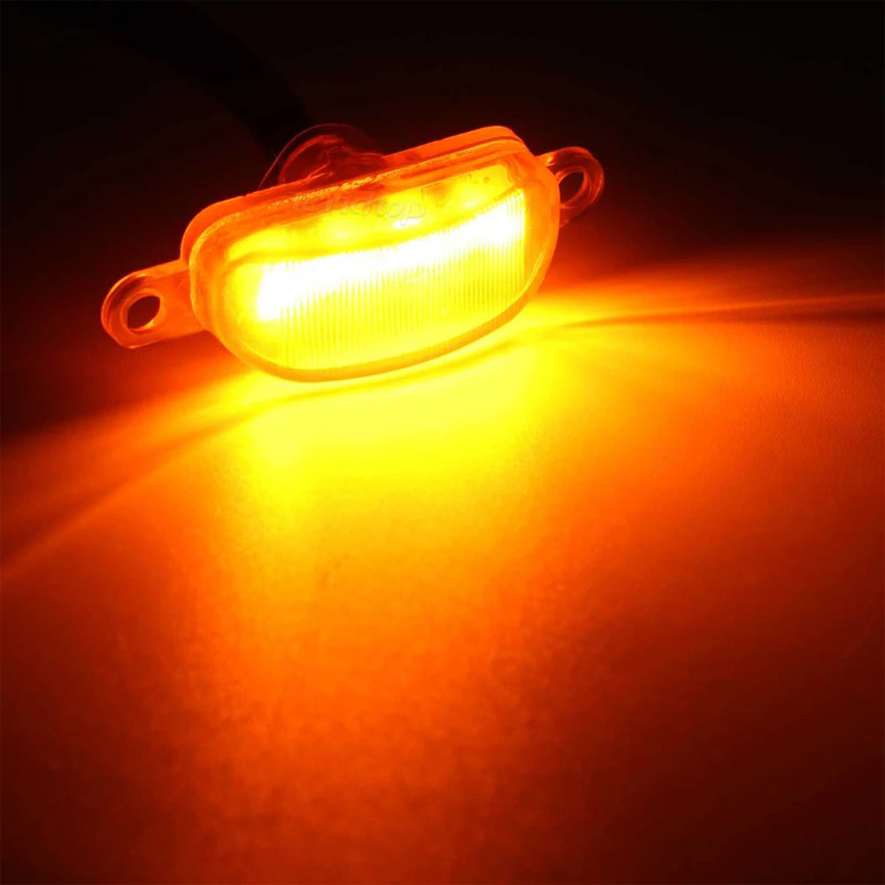 A bright yellow LED light kit mounted on a grille, illuminating the surrounding area.