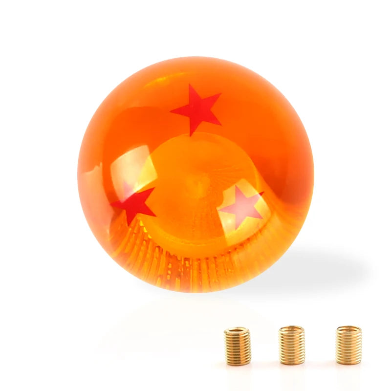Maneta de cambios redonda, de color ámbar con emblema de estrella roja y herrajes de latón.