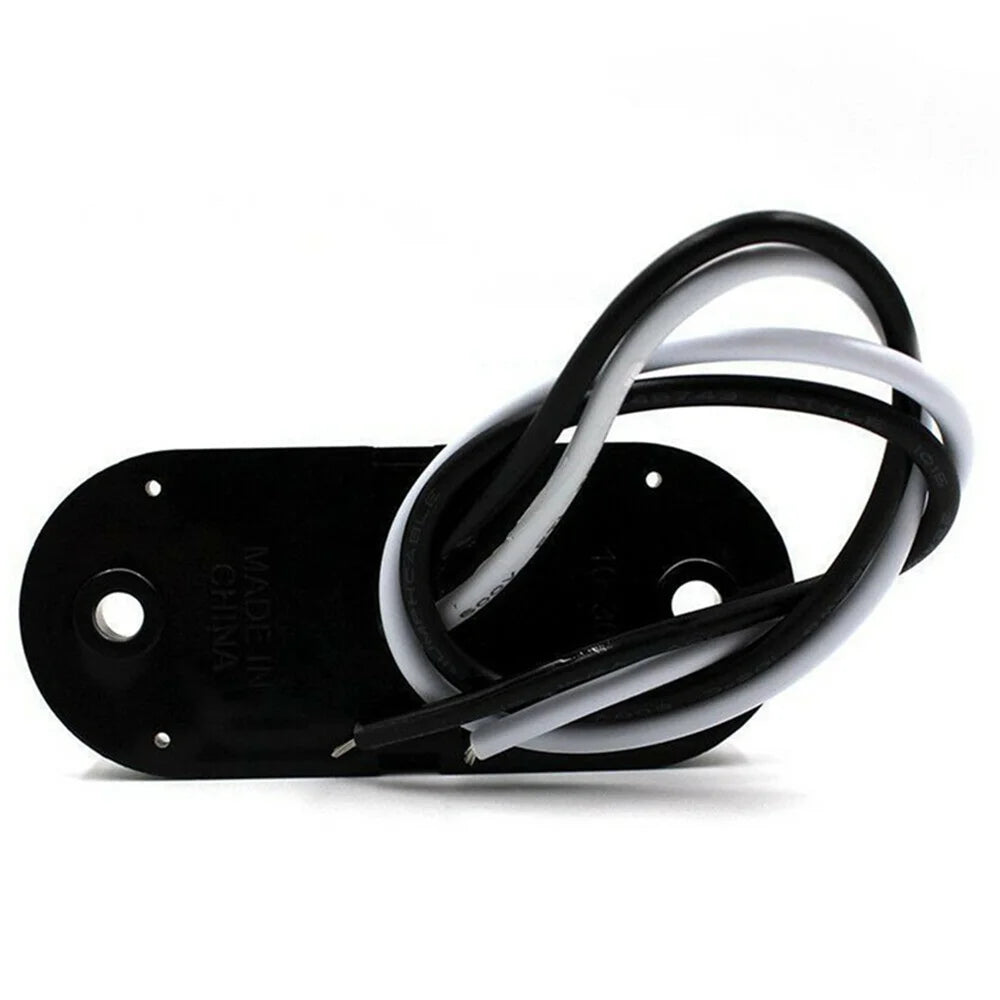 Black electrical connector with a coiled white and black wire harness for universal LED warning lights.