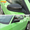 Close-up view of a green Ford Mustang with a black ABS protection shell rearview mirror cover installed on the side.