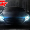A close-up of a car's front end with bright blue LED daytime running lights illuminated against a dark, smoky background.
