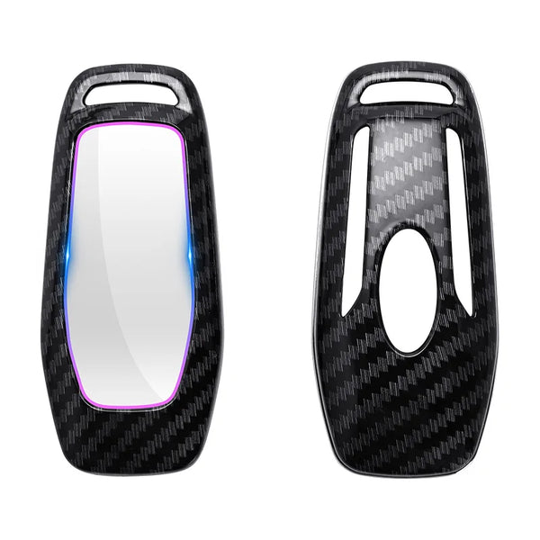A black carbon fiber car key cover with a clear window and purple accent.