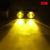 A pair of bright yellow halogen fog lights illuminating a road surface at night.