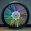 A black motorcycle wheel rim with numerous colored spokes, including blue, green, yellow, and red.