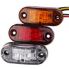 Three universal LED warning lights for trucks and trailers shown in amber, red, and clear plastic casings.