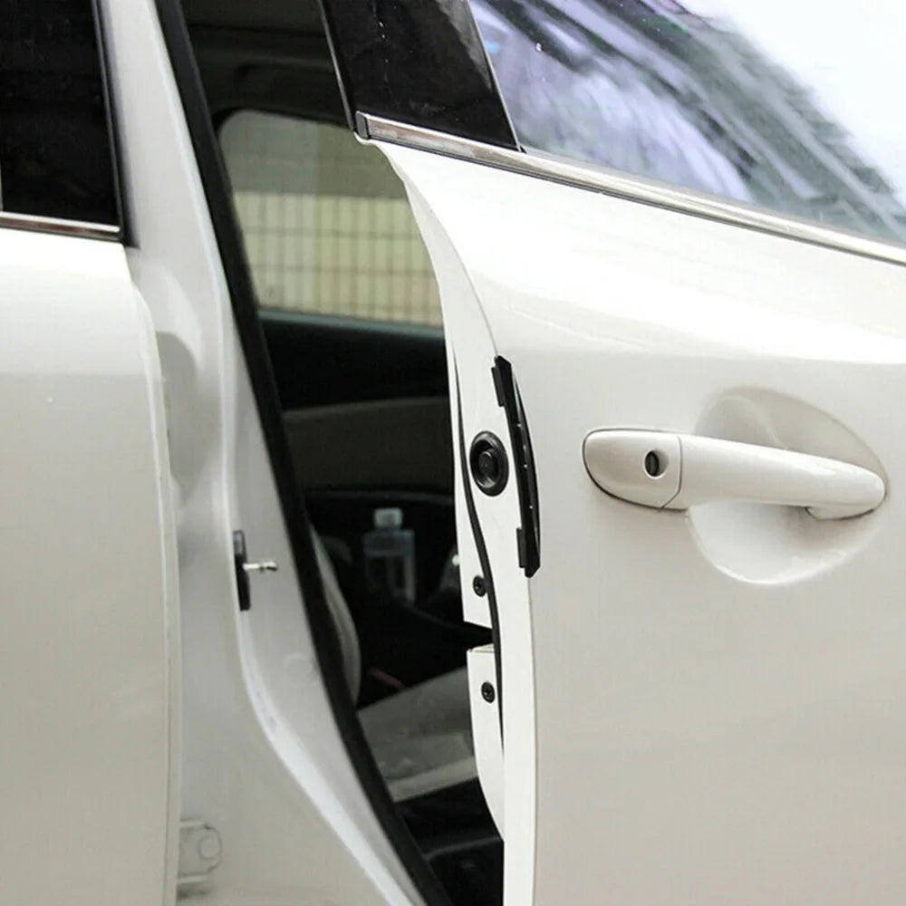 Close-up view of a white car door with an edge protector strip and handle, showing the interior and exterior trim.