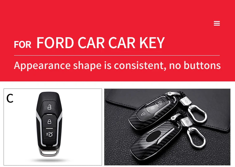 A close-up view of a black carbon fiber car key cover with a silver keyring, resting on a dark surface.