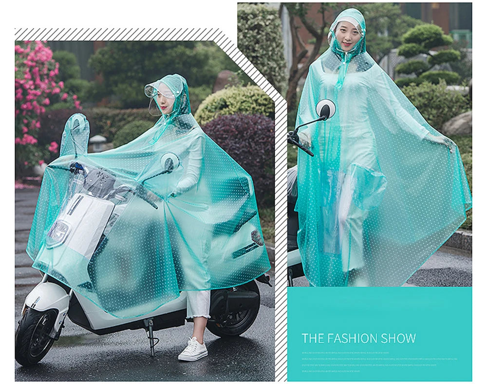 A woman wearing a transparent windproof motorcycle rain poncho rides a scooter on a wet street.