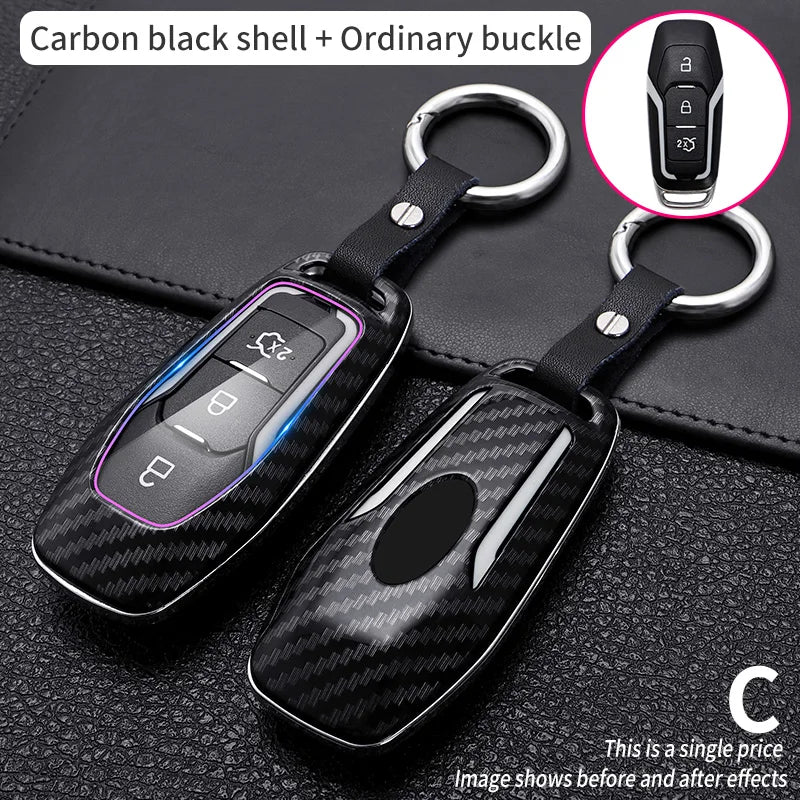 Carbon black shell key cover with ordinary buckle and a separate key fob shown against a dark background