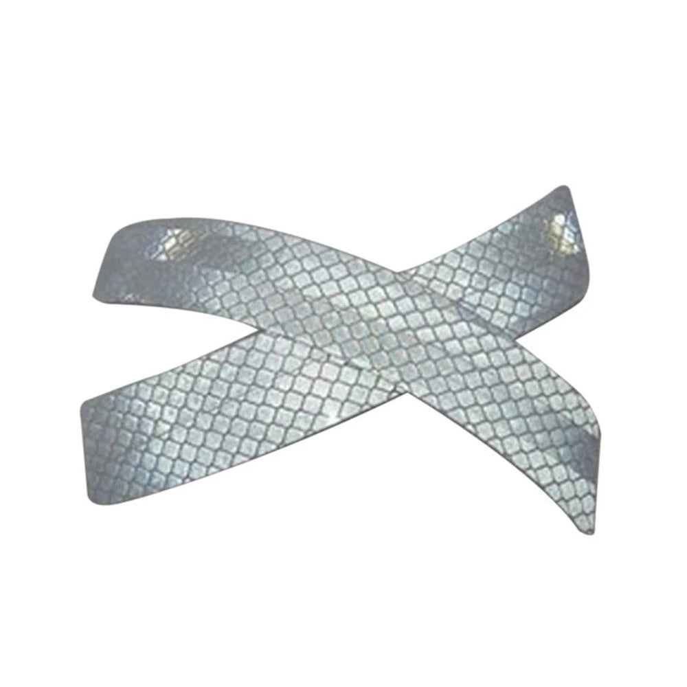 A pair of silver dual reflective car bumper warning strips crossed in an 'X