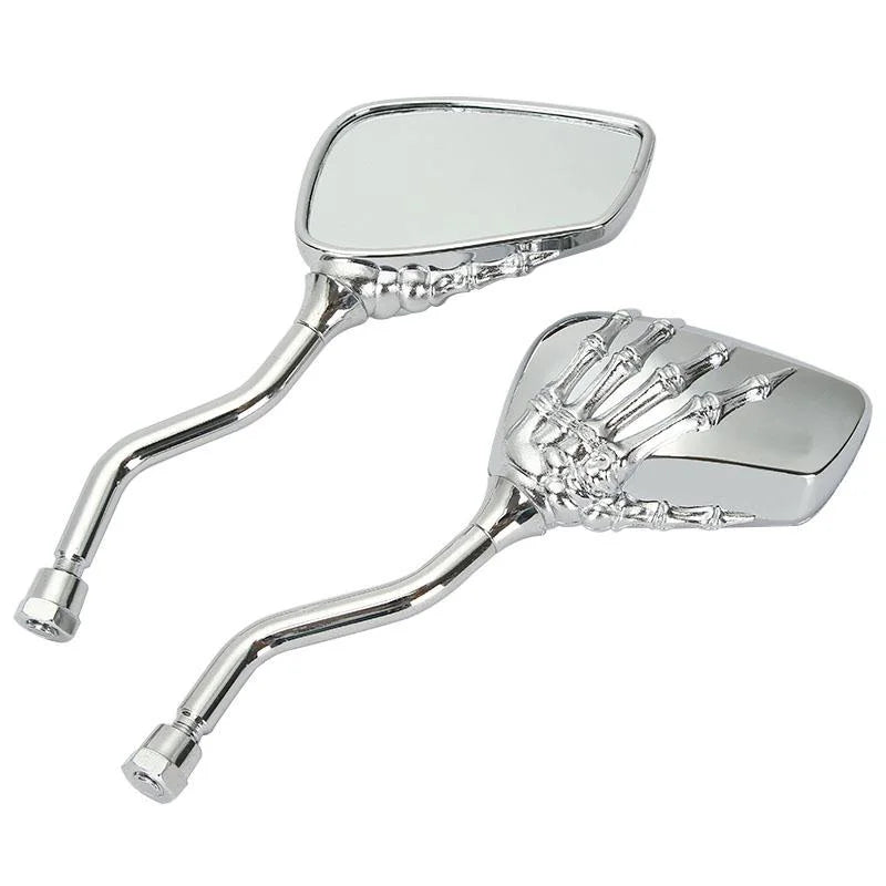 A pair of chrome universal skull hand motorcycle side mirrors.
