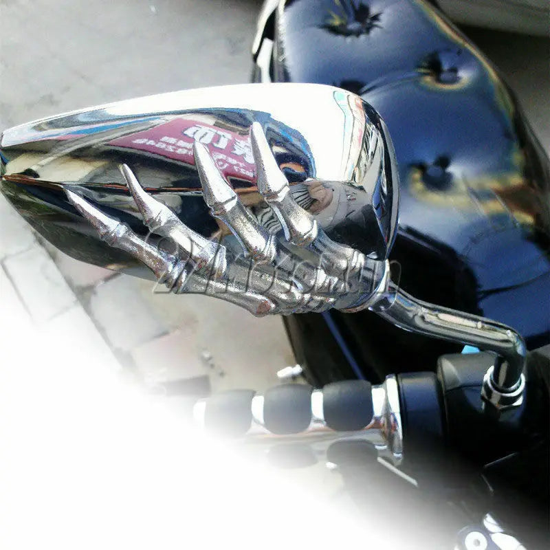Chrome motorcycle side mirrors featuring a skull hand design.
