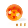 Maneta de cambios naranja brillante con estrellas rojas y detalles de latón.