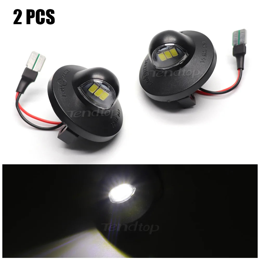Two LED license plate lights with connectors shown against a dark background.