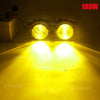 A pair of 100W halogen fog lights illuminating a bright yellow surface.
