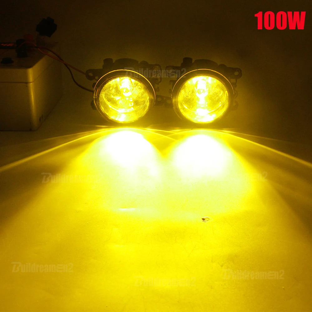 A pair of 100W halogen fog lights illuminating a bright yellow surface.