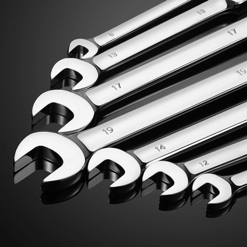 A close-up view of a set of silver flexible pivoting head ratchet wrenches with numbered teeth.