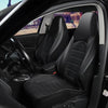 Interior view of a car showing black faux leather seat covers on the front and split bench seats.