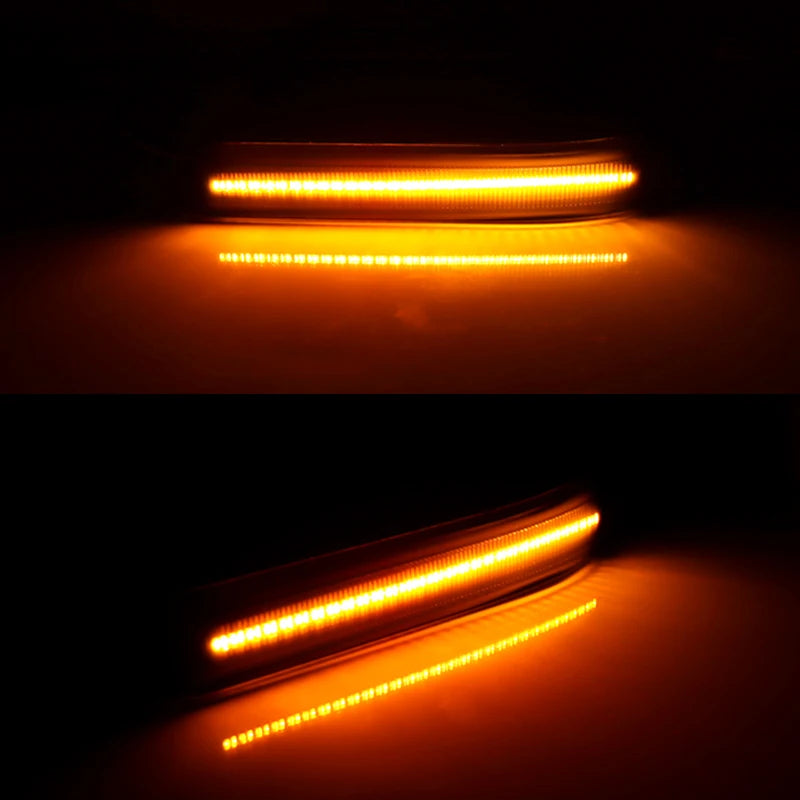 Close-up view of amber LED side mirror marker lights illuminating a surface.