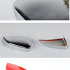 A set of automotive rearview mirror covers in black, silver, and red plastic shells.