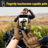 A person wearing tactical gloves is using a smartphone with a fingerprint touchscreen to take a photo outdoors.