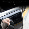 Close-up of a hand installing a black door protection strip on a car door panel.
