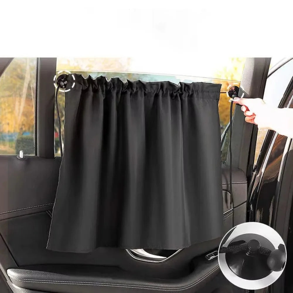 Black suction cup window sunshade installed on a car window.