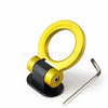 A gold decorative racing tow hook sticker with a black mounting base.
