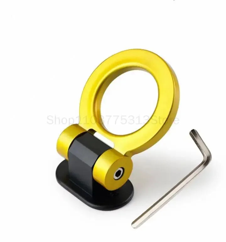 A gold decorative racing tow hook sticker with a black mounting base.