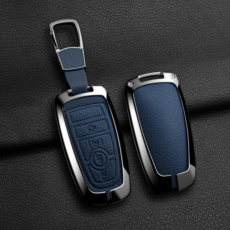 A sleek, dark blue aluminum alloy key fob cover for a Ford vehicle, shown with its attached lanyard.