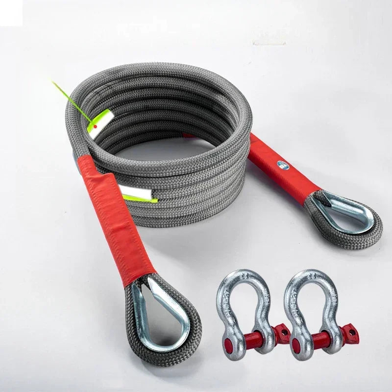 A coil of heavy duty vehicle towing rope with red and silver hooks and a red handle.