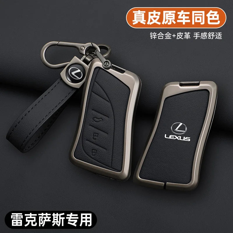 A leather key cover shell with a metal clasp and a strap, shown against a dark background.