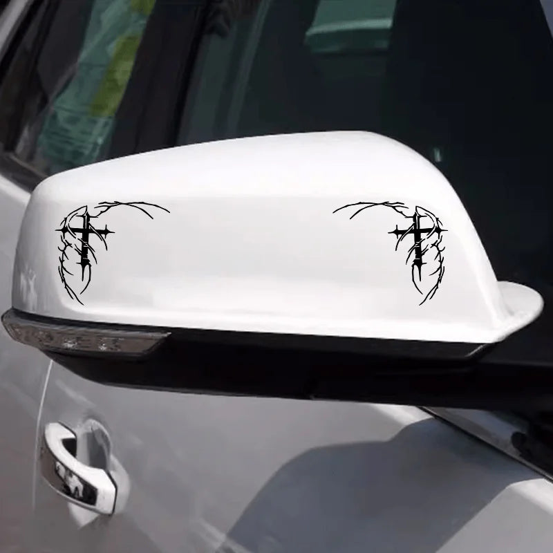 White car decal featuring a black gothic thorn cross design on the hood.