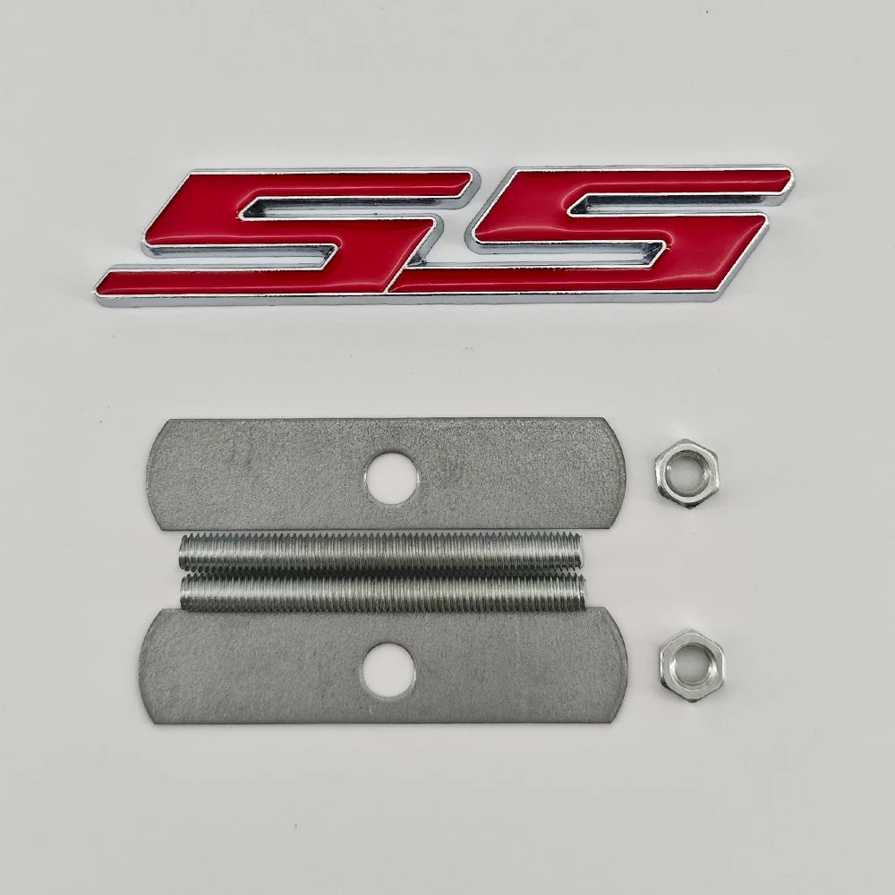 A red and silver SS emblem badge and two metal mounting plates for Chevrolet vehicles.
