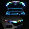 Close-up of an RGB LED light strip installed on the hood of a white car.
