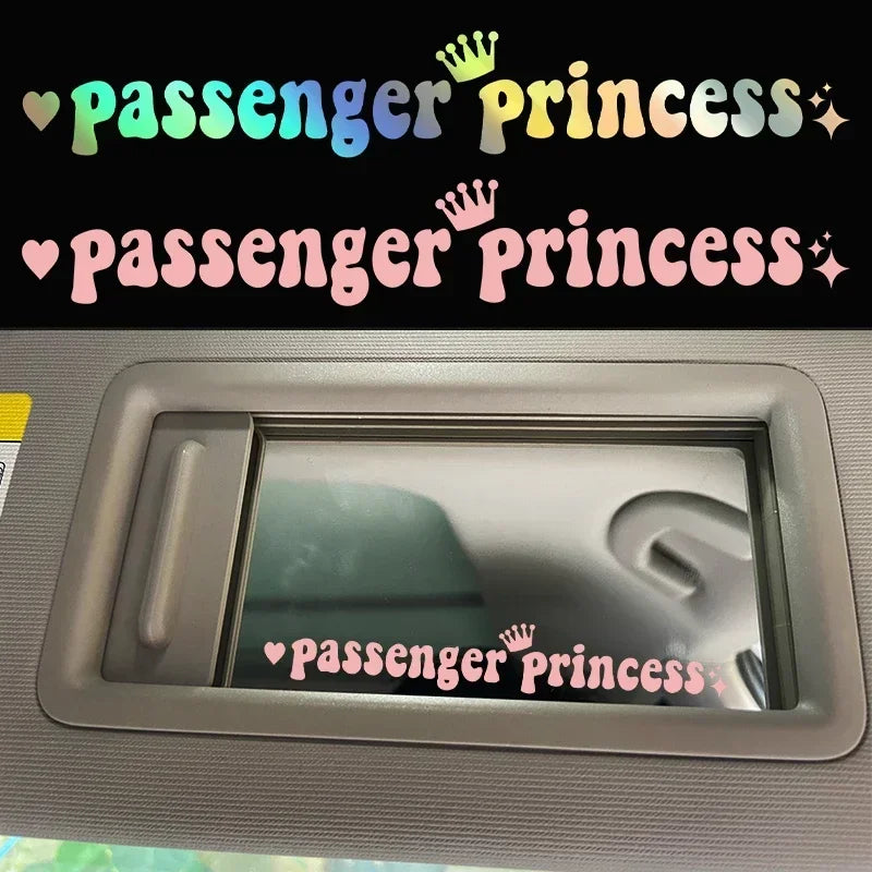 A close-up of a car rearview mirror showing a pink princess sticker on the glass.