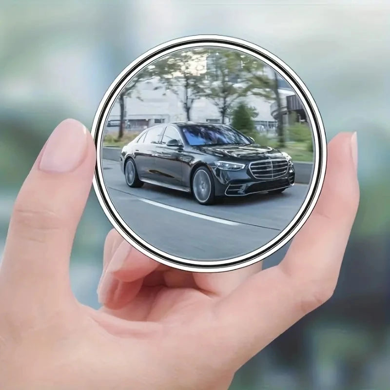A hand holds a circular view of a black Mercedes-Benz sedan, demonstrating 360° adjustable blind spot mirrors.
