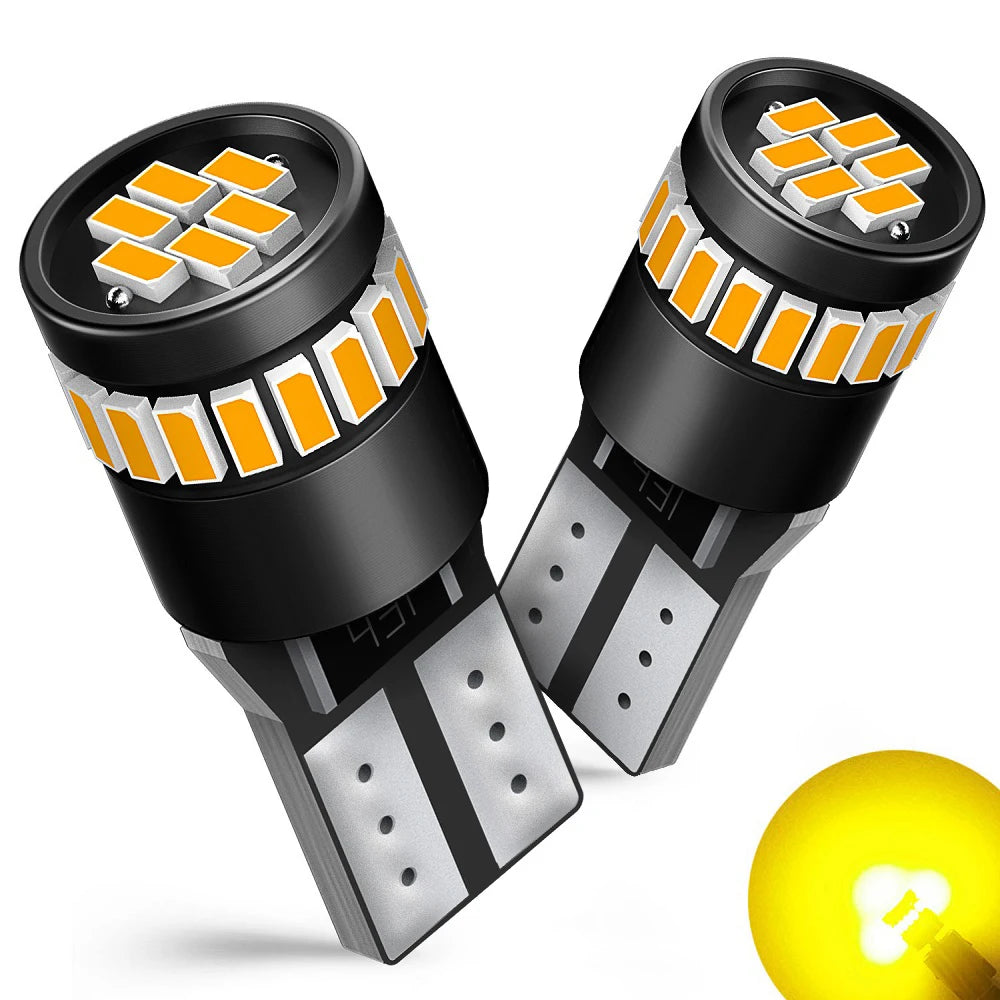 A close-up view of Canbus Error-Free T10 LED bulbs with orange and white lenses and silver bases.