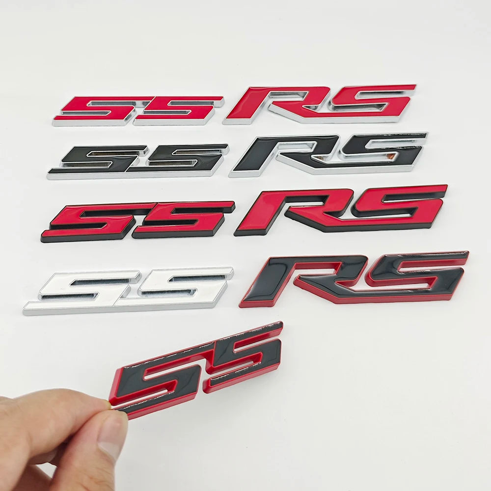 A collection of various 3D metal SS/RS emblem badges in silver, red, and black finishes.