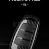 A close-up view of a black carbon fiber style car key case cover with multiple buttons and a circular detail.